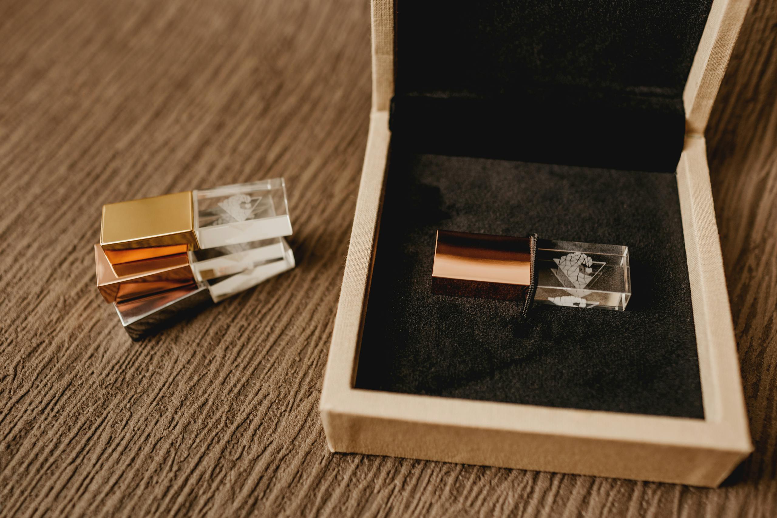 High angle of pile of modern pen drives against wooden box for gift on rough surface